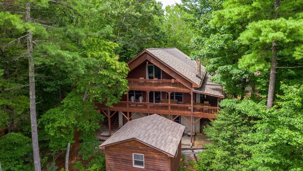 A two-story wooden cabin surrounded by dense forest. - Heavens Hideaway - 4 bedroom with views, allows pets, game tables (Lenoir)