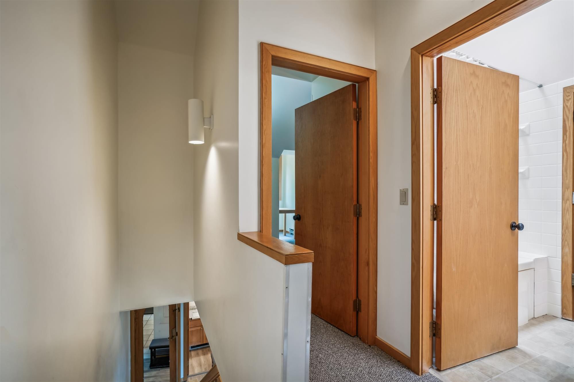 Upper-Level Hallway and Bath Access - Easy access to upstairs bedrooms and bathrooms with an open loft-style layout.