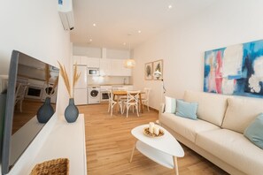 A modern apartment with a living room, dining area, and kitchen. - Apartamento Merida 2 (Nerja)