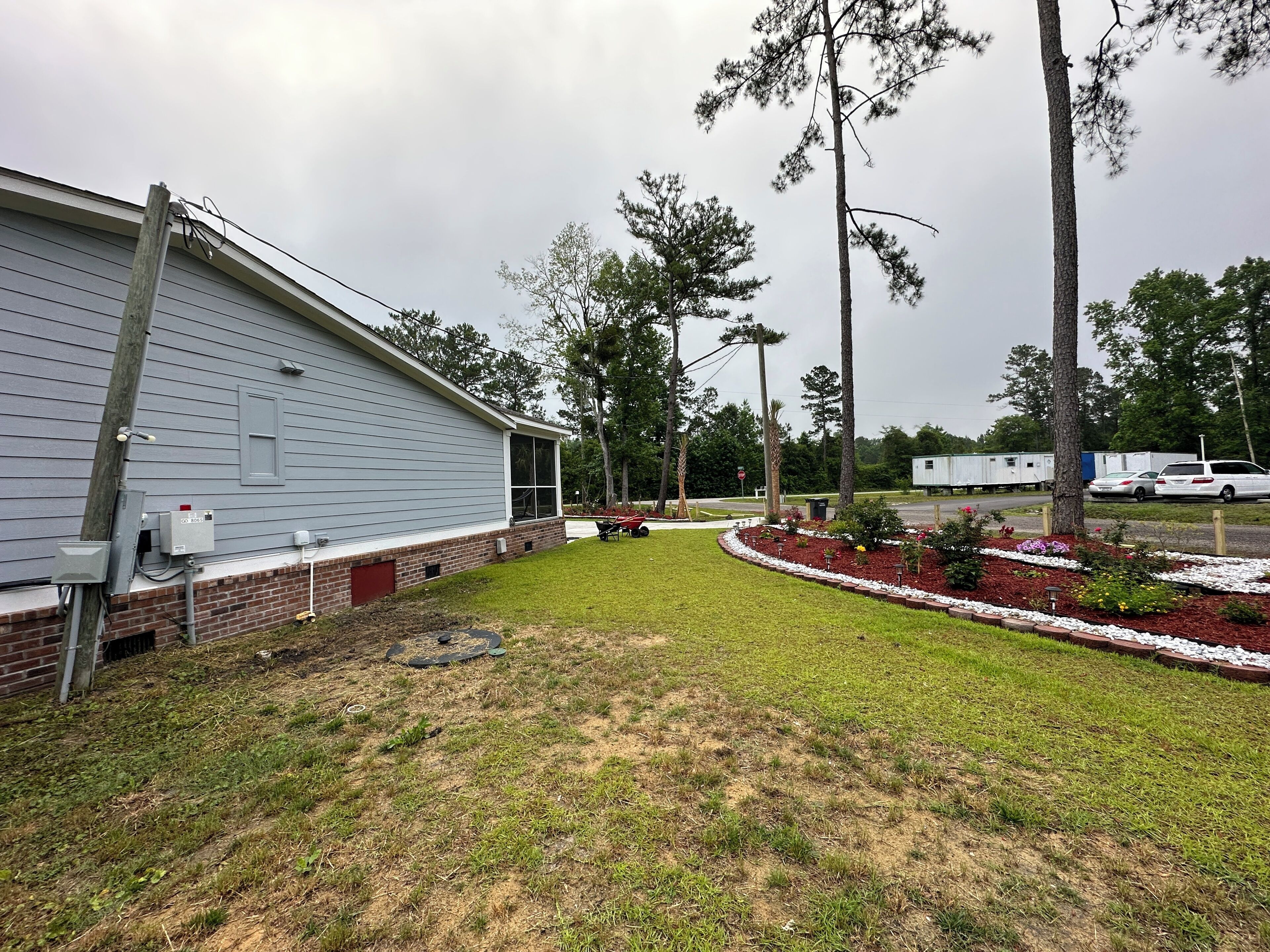 A residential area with a house, a lawn, and a driveway.