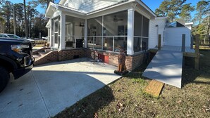 A house with a covered porch, a garage, and a fenced yard. - Cozy 4-bedroom house in welcoming Longs with WiFi, AC (Longs)