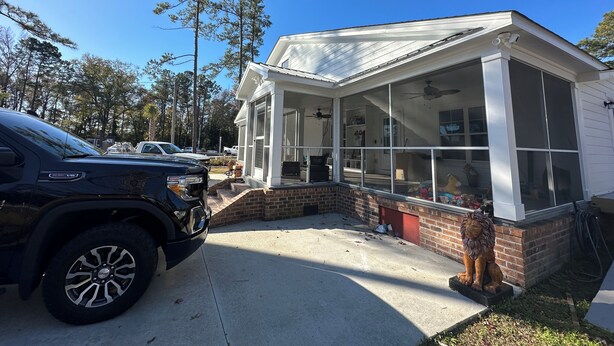A house with a covered porch, brick foundation, and a garage. - Cozy 4-bedroom house in welcoming Longs with WiFi, AC (Longs)