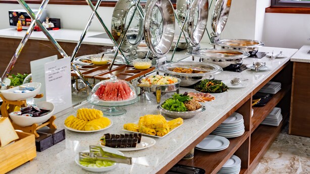 Una mesa de buffet con diferentes alimentos y utensilios.