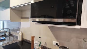 Microwave, electric kettle, cookware/dishes/utensils, spices