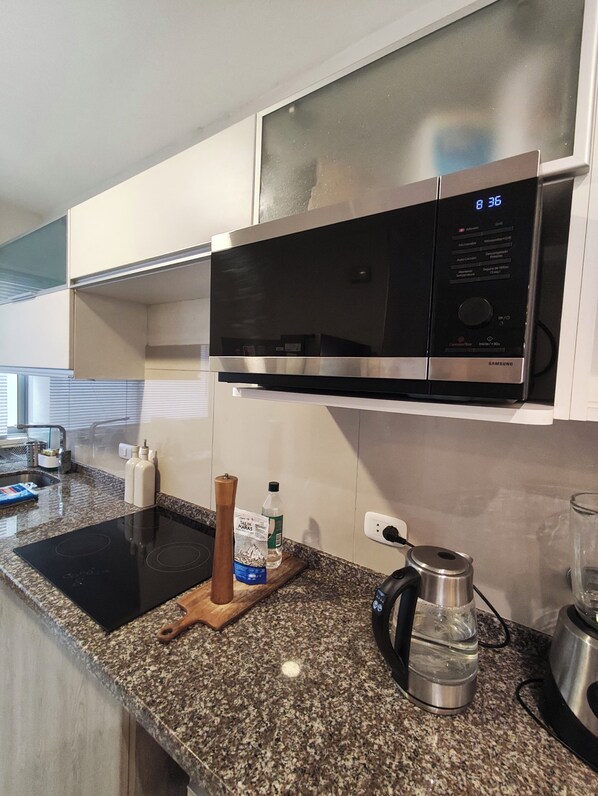 Microwave, electric kettle, cookware/dishes/utensils, spices