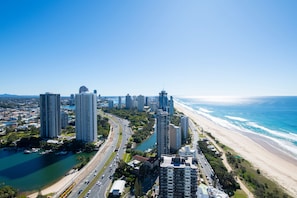 A coastal cityscape with high-rise buildings, a beach, and a river. - Rhapsody Stunning Ocean Views Apartment (Surfers Paradise)