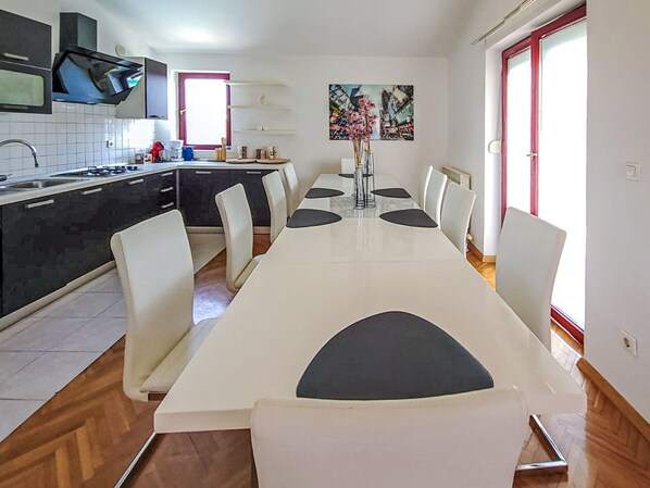 A modern kitchen with a dining area.