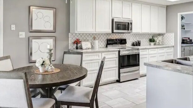 A modern kitchen with white cabinets, a built-in microwave, and a ceiling fan. - Relaxing 3BR Family Retreat. Spacious • Peaceful • Close to everything (Peralta)