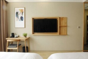 A hotel room with two beds, a desk with a chair, a blackboard, and a framed abstract painting. - Chongqing Yishi Rongtai Hotel (Chongqing)