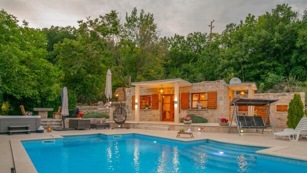 A swimming pool with a stone building and outdoor seating area. - Villa Mia 2 (Podbablje)