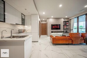 Panoramic Apartment, 1 Bedroom, Balcony, City View | Living area | 32-inch flat-screen TV with cable channels