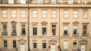 A row of townhouses with uniform architectural style, featuring multiple windows and doors, and a consistent facade. - The Paragon Penthouse - Stunning Views over Bath! (Bath)