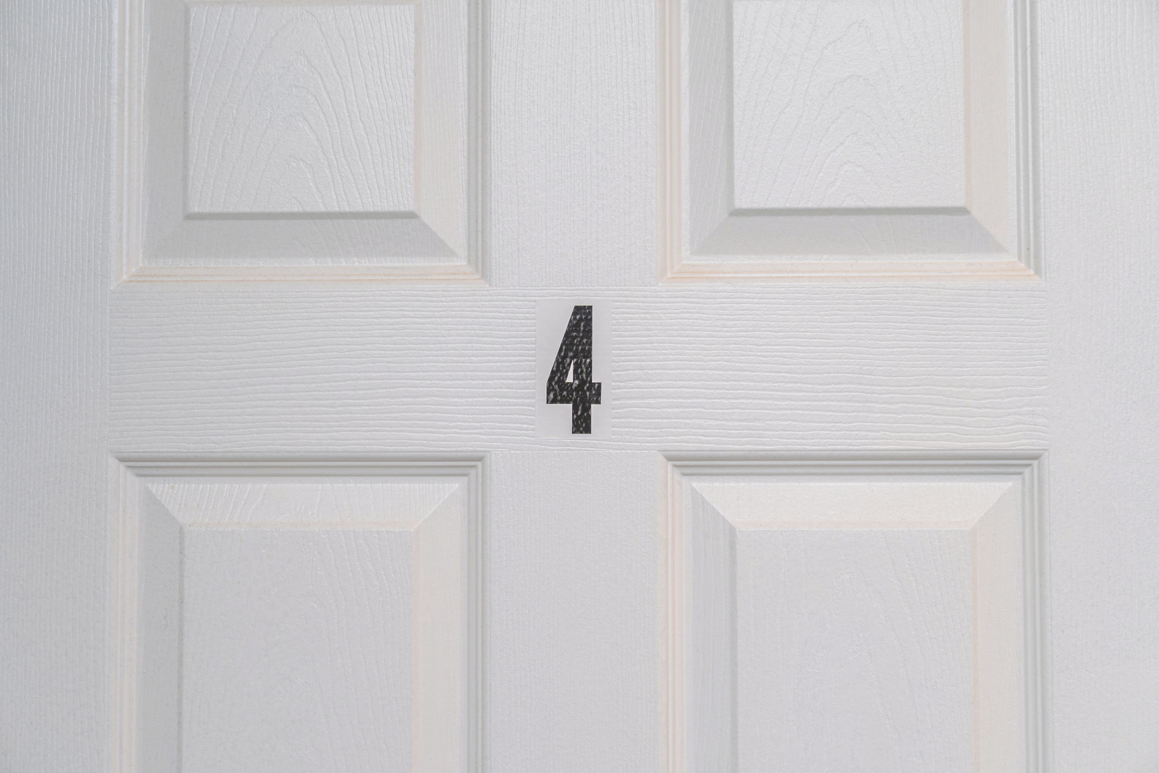 A white door with a number '4' centered on it.