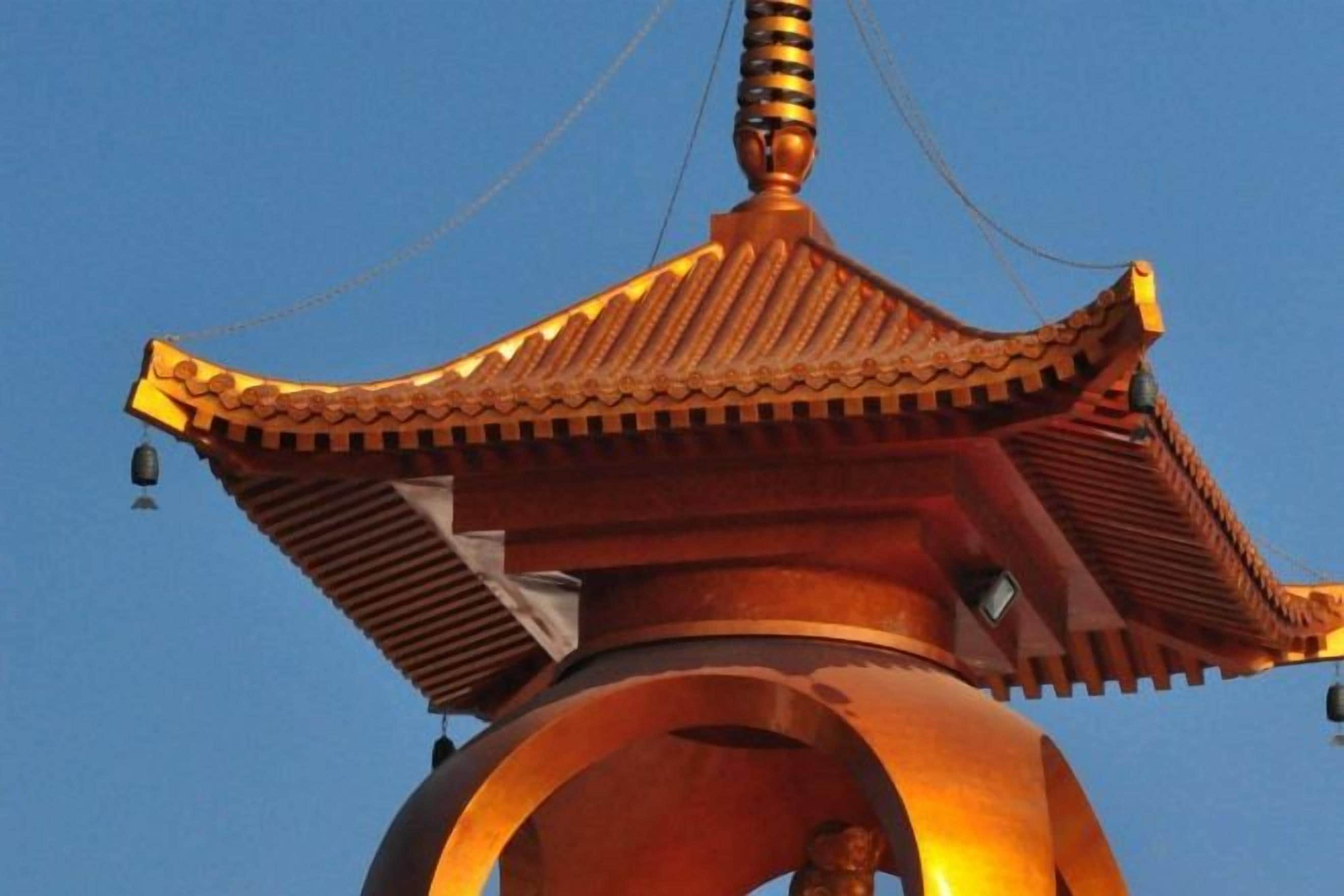 A traditional pagoda-style structure with a curved roof and a central pillar.