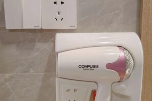 A white hairdryer with a pink accent and the text 'CONFU' and 'Fashion Style' on it. - Shexian Shendu Wenfa Hotel (She County)