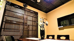 Una tradizionale stanza giapponese con pavimento in tatami, un tavolino basso e una porta scorrevole.