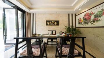 A conference room with a long table, chairs, and a decorative wall piece.