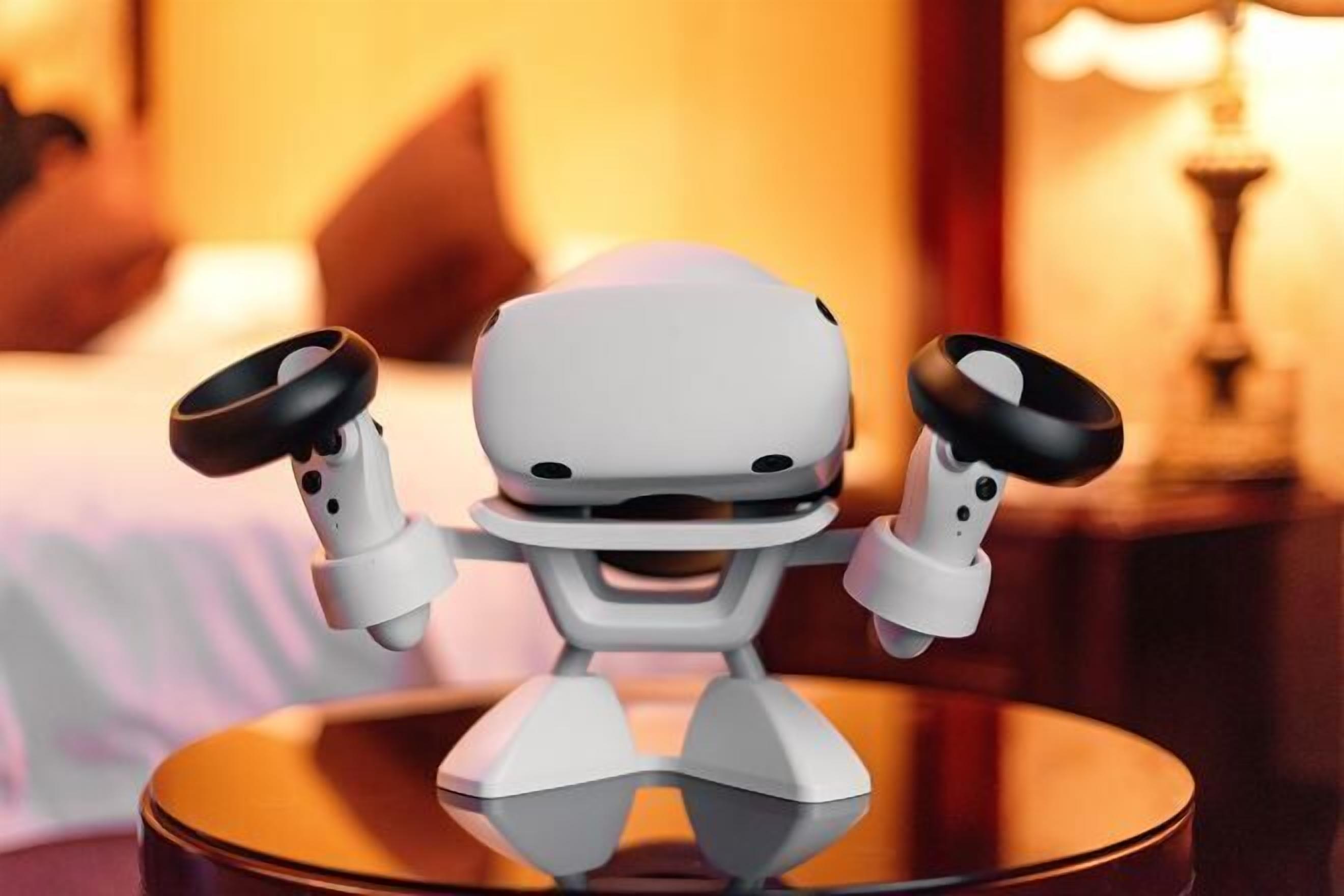 A robot with arms raised, standing on a round table.