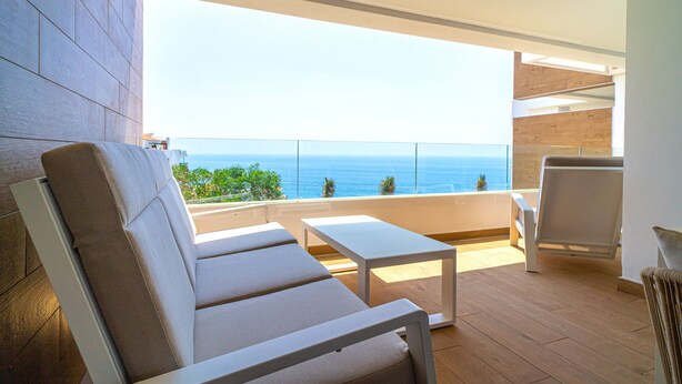 A balcony with a view of the sea, furnished with a sofa and a table. - Luxury Premium Isea 1122 by Casasol (Torrox Costa)