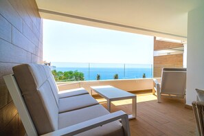 A balcony with a view of the sea, furnished with a sofa and a table. - Luxury Premium Isea 1122 by Casasol (Torrox Costa)