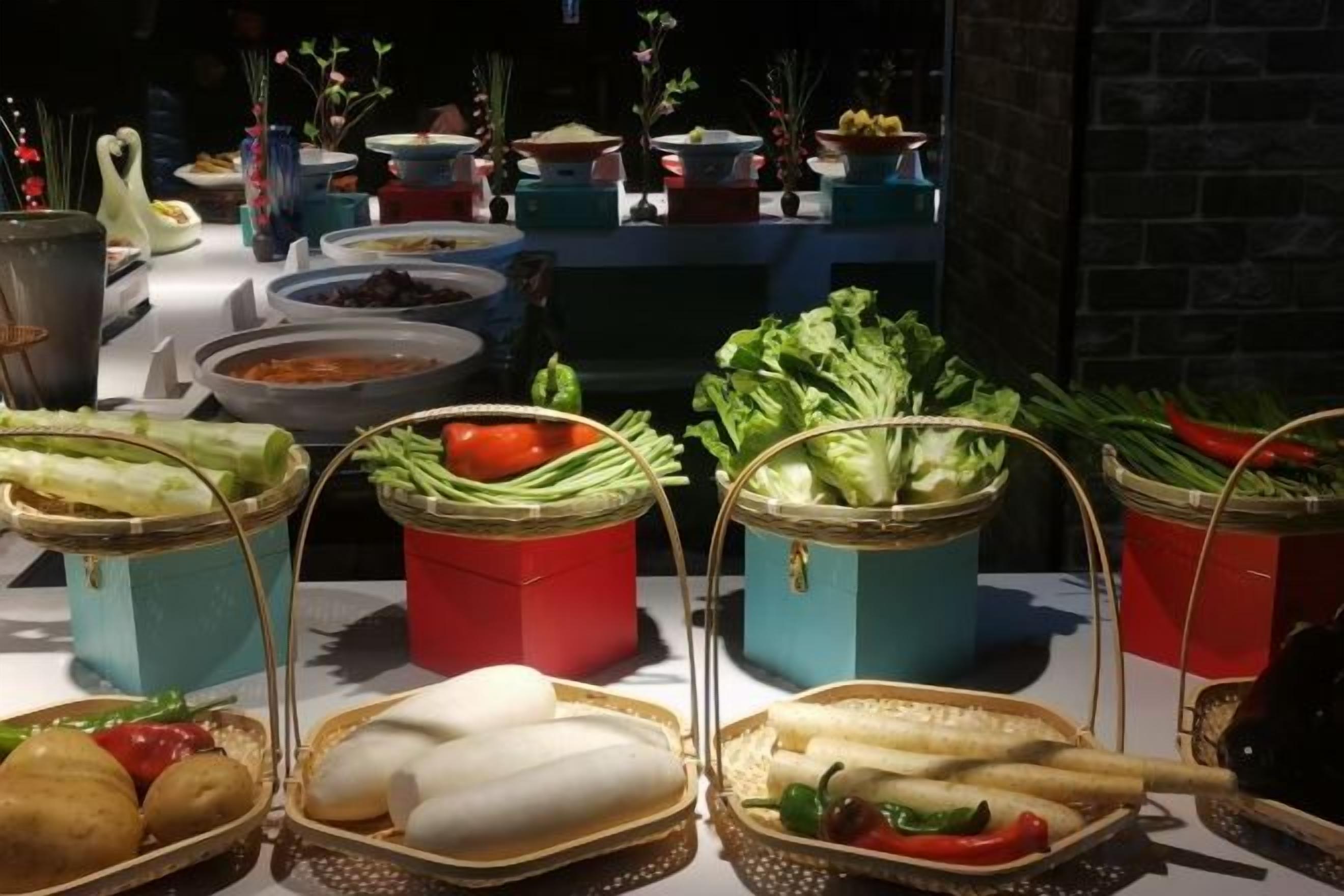 A buffet table with various food items and containers.
