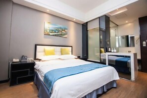 A modern hotel room with a large bed, bedside tables, a desk, and a large mirror. - Yicheng Hotel (Henan University of Technology) (Zhengzhou)