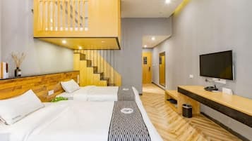 A hotel room with a bed, a TV, a wooden staircase, and a hallway.