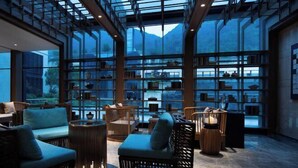 A spacious interior with large windows, wooden furniture, and a glass ceiling. - YunXi DengYun Resort Hotel (Xianju)