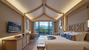 A hotel room with a bed, a TV, a desk, and a balcony with a view. - YunXi DengYun Resort Hotel (Xianju)