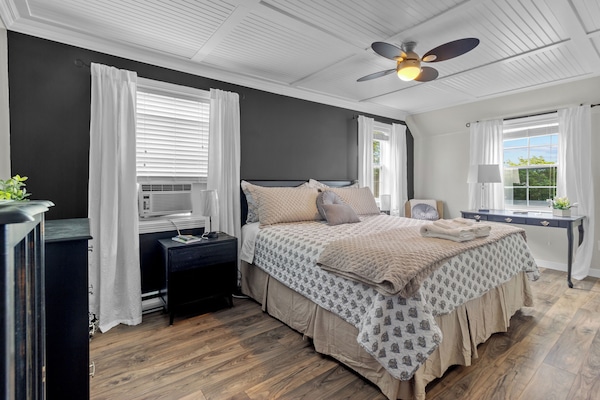 Another view of the primary bedroom showcases the ample closet space and stylish furniture, providing a luxurious and restful retreat.
