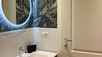 Shower, rainfall showerhead, bidet, towels