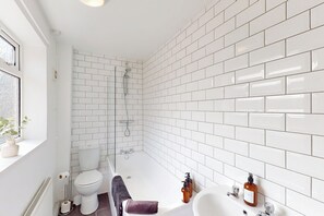 Combined shower/bathtub, deep-soaking bathtub, hair dryer, towels