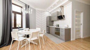 A modern kitchen with a built-in oven, microwave, and a large window. - Native Apartments Blich 7 (Kraków)