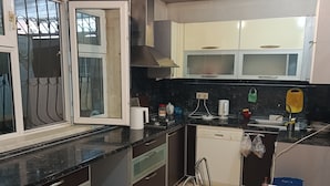 A kitchen with a stove, sink, and cabinets. - Freestyle Hostel Baku (Baku)