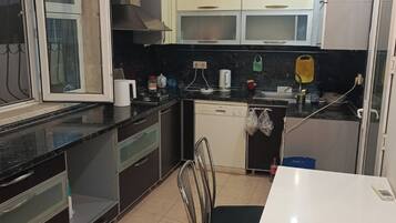 Basic Condo | Shared kitchen facilities | Full-size fridge, paper towels