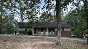A two-story house with a porch and a small front yard. - Lakefront Home in Cabot (Cabot)