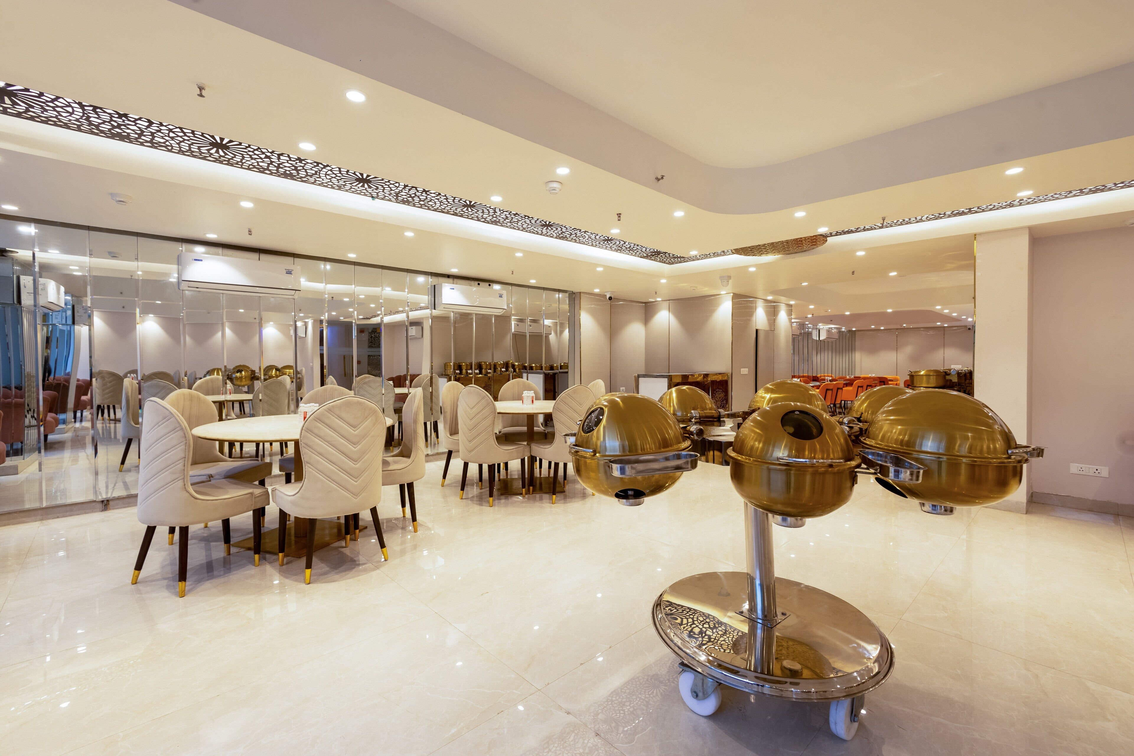 A modern dining area with round tables and chairs, a central decorative element, and a glass partition.