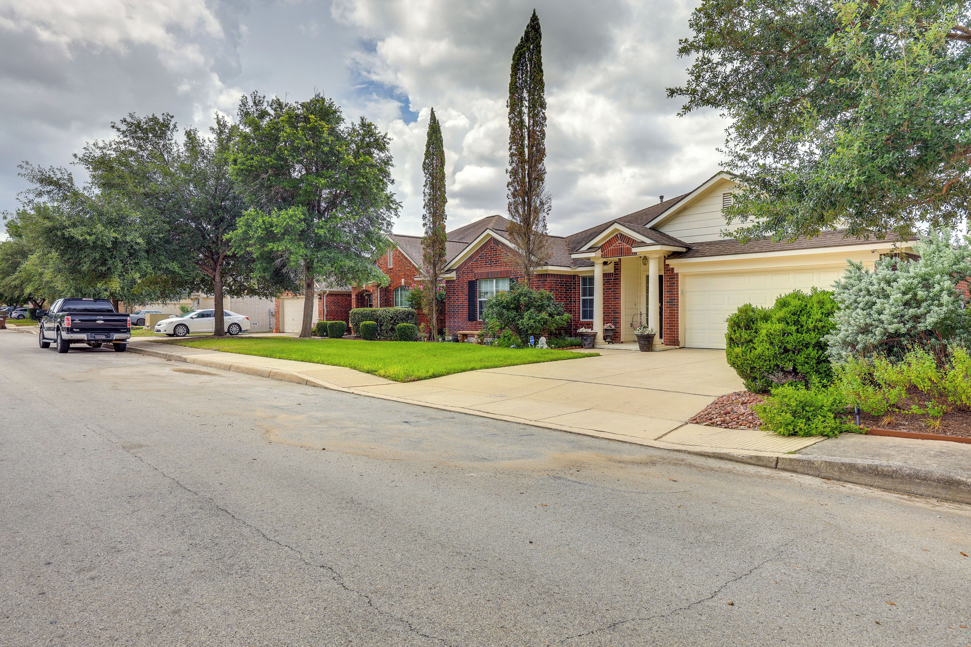 A suburban house with a garage, a driveway, and a well-maintained lawn.
