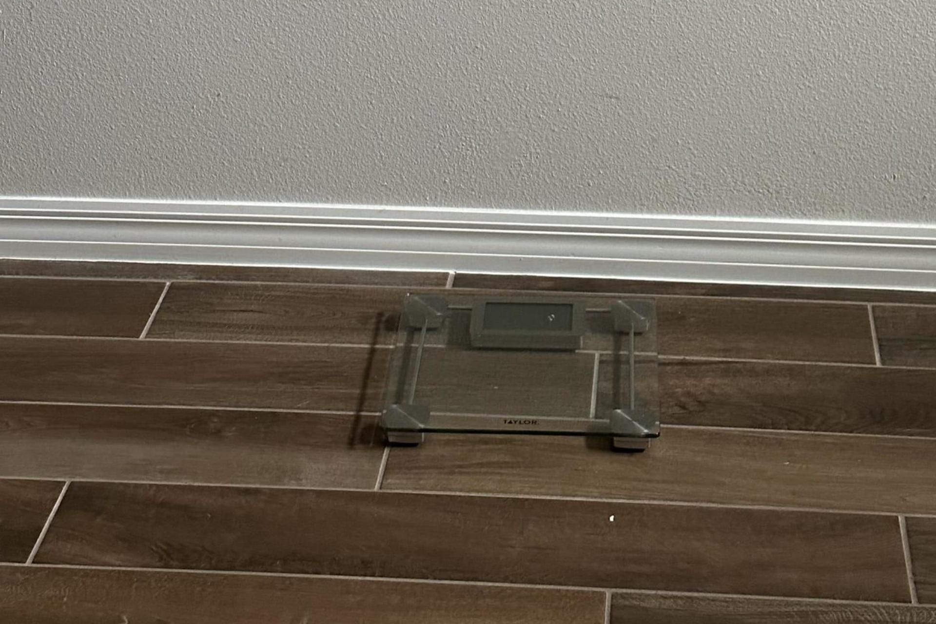 A small, rectangular object on a tiled floor near a wall.