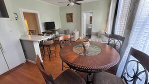 A dining area with a round table, chairs, a ceiling fan, and a kitchen in the background. - Huge 3 Bedrooms Apt 15 Minutes to NY City (West New York)