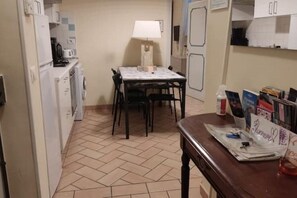 A small kitchen with a dining table and chairs, a lamp, and a refrigerator. - Centralissimo: Comodo per 3, Economico per 6 :-) (Firenze)