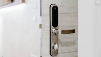 A modern door with a metallic handle and a keyhole, indicating a secure entry point.