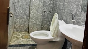 A bathroom with a shower, toilet, and sink. - Goza Guest House (Addis Ababa)