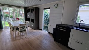 A kitchen with a dining area, a sink, and a window.