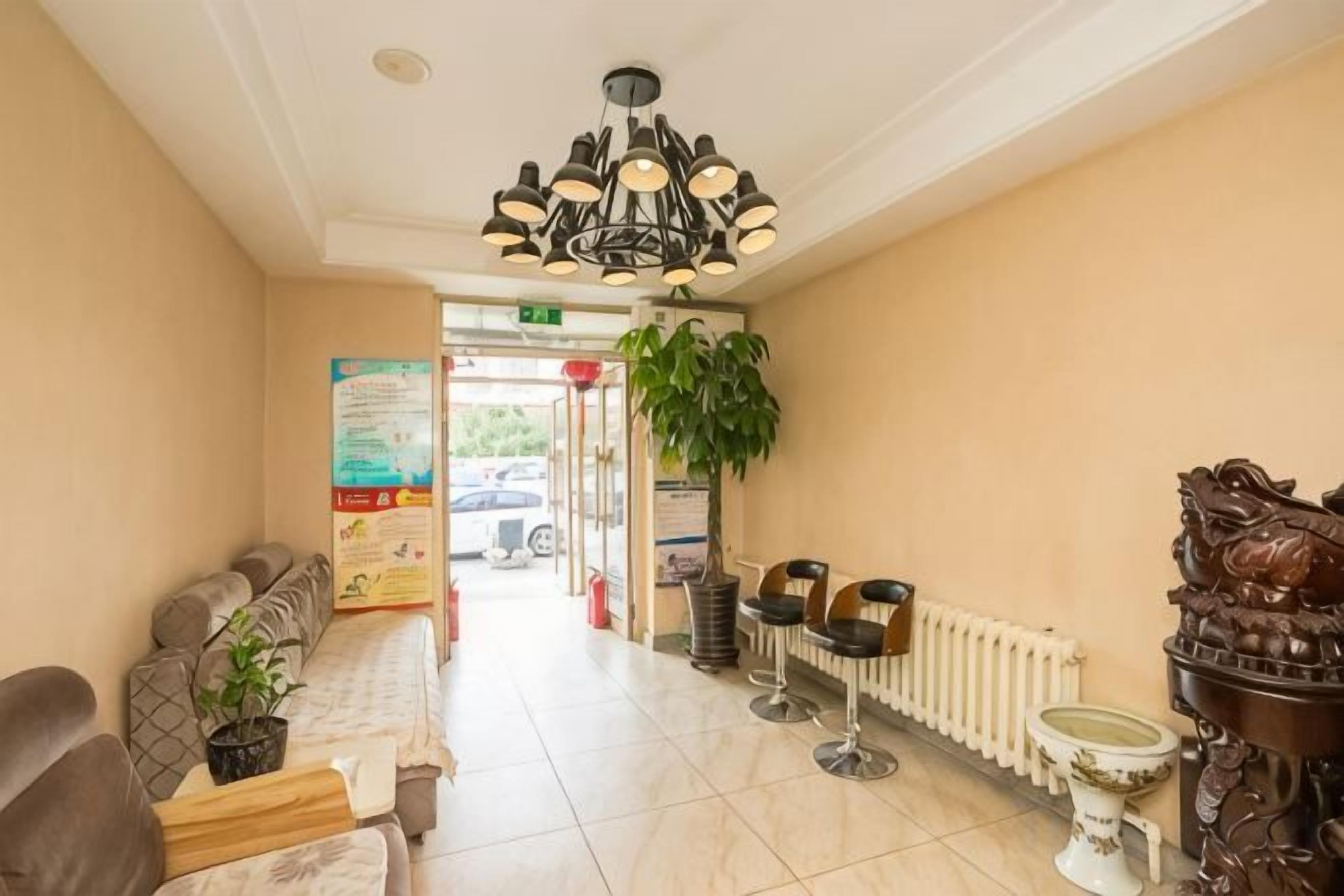 A hotel lobby with a reception desk, seating area, and a radiator.