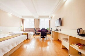 A hotel room with two beds, a desk, a chair, a TV, and a bookshelf. - Qilong Hotel (Harbin Government Civil Aviation Building Shop) (Harbin)