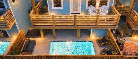 Ein Poolbereich mit Holzterrasse und Whirlpool.