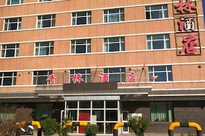 A multi-story hotel with a prominent sign above the entrance. - Qinglin Hotel (Qinggil)