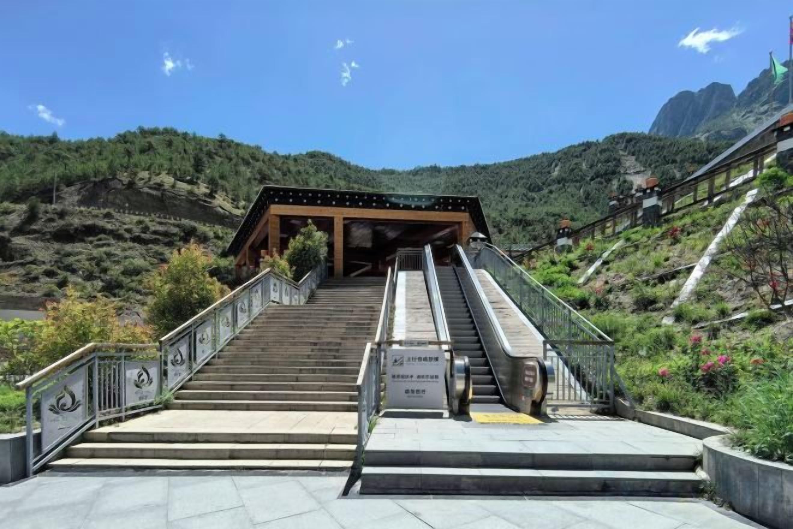 A staircase leading to a covered area with a view of a mountainous landscape.