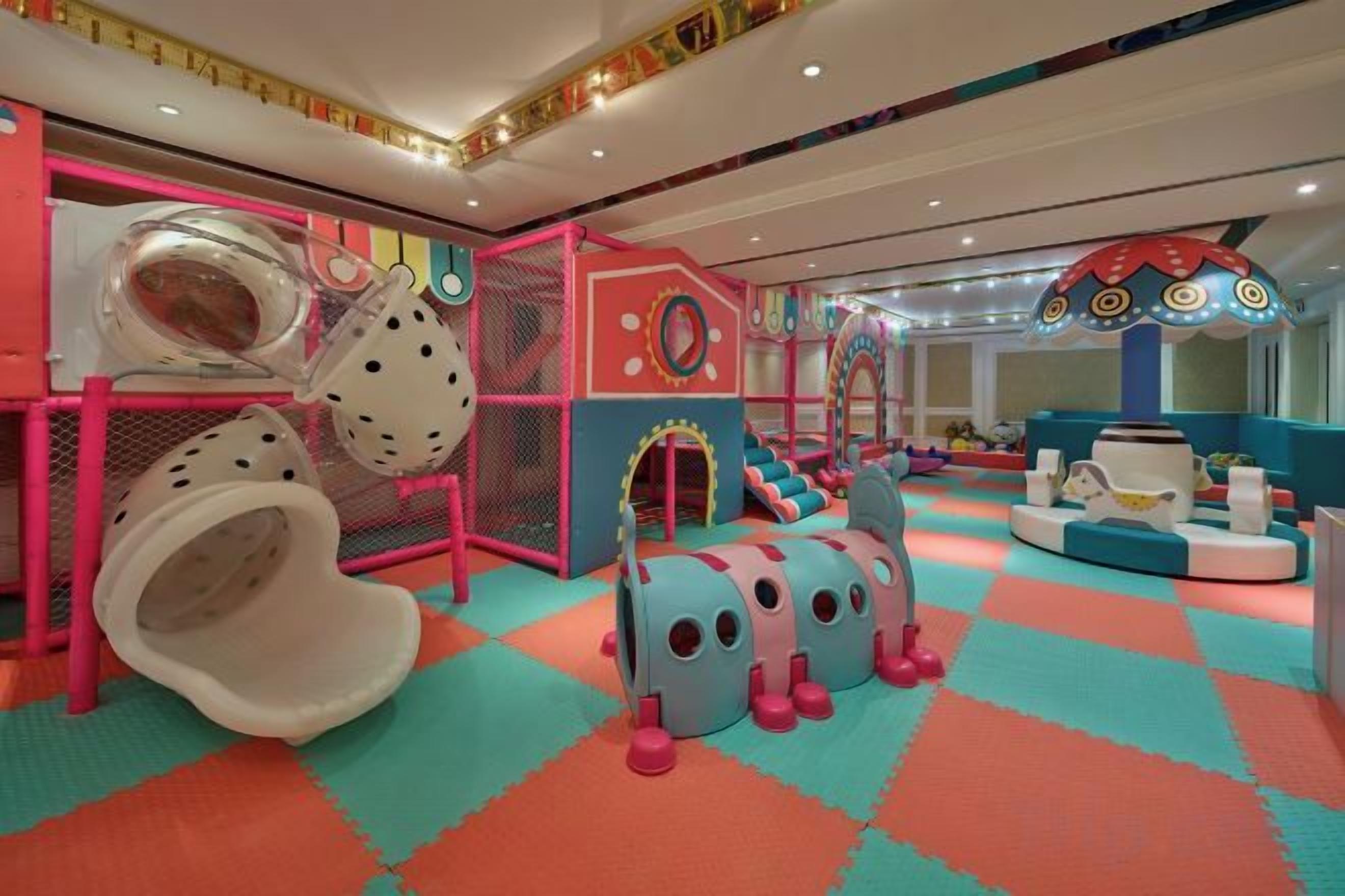 A children's play area with slides, tunnels, and soft play structures.